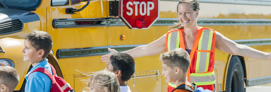 Crossing guard helps students walk to bus