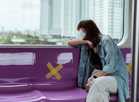 Person wearning mask, riding on public transit. Photo by Ketut Subiyanto via Pexels