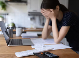 Young woman in distress while reviewing finances