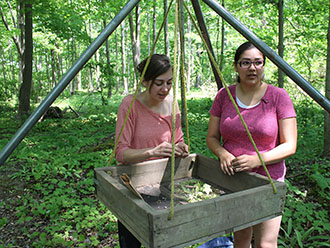 Nadine Finaly and Shauna Kechego-Nichols sort findings in field school