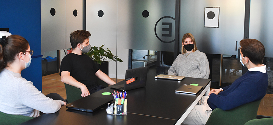 Students at desk in office meeting room